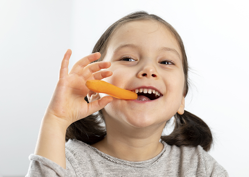 Girl Biting Carrot.